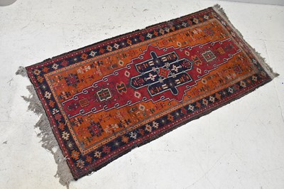Lot 1159 - A Caucasian hand woven wool rug, worked with a...