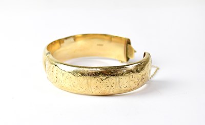 Lot 978 - A 9ct yellow gold chased bangle, approx. 24.7g.