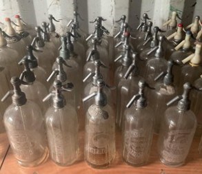 Lot 75 - Thirty glass soda syphons with metal or chrome...