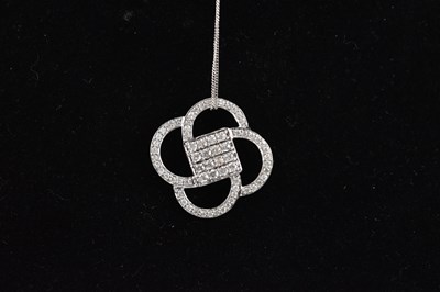 Lot 386 - A 9ct white gold diamond set cluster pendant...