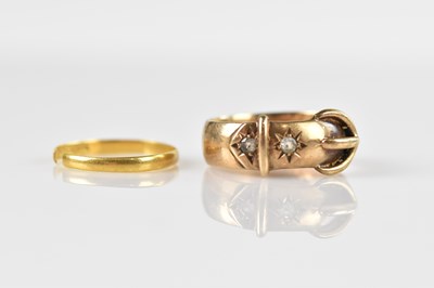 Lot 637 - A 9ct yellow gold buckle ring set with two...