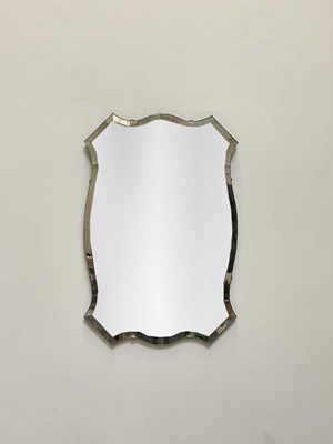 Lot 1024 - A 20th century shaped bevelled wall mirror, 70...