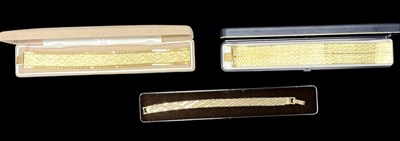 Lot 1530 - A textured yellow metal cuff bracelet, marked '...