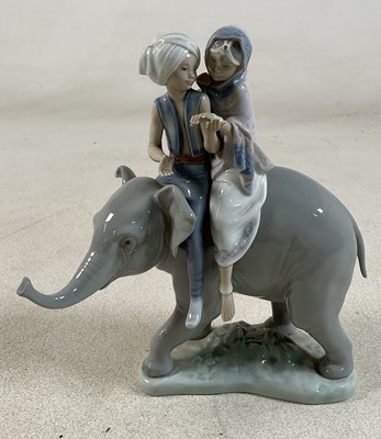 Lot 191 - LLADRO; a figure group of an Indian boy and...