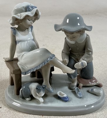 Lot 194 - LLADRO; a figure group, 'Try This One',...