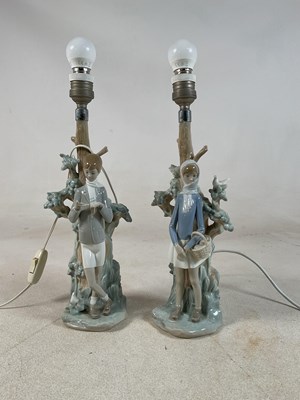 Lot 199 - LLADRO; two figural table lamp bases, a young...