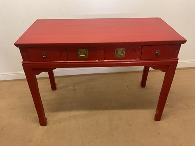 Lot 643 - An Oriental red lacquered hall table, with...