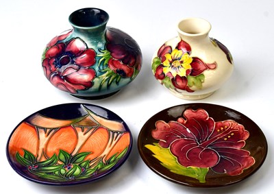 Lot 157 - MOORCROFT; two squat vases, Anemone pattern...