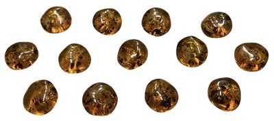 Lot 1467 - Thirteen circular amber beads, combined approx...