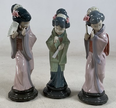 Lot 202 - LLADRO; three figures of Japanese geisha girls,...