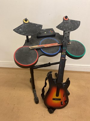 Lot 114 - GUITAR HERO; a set of drums and guitar used...