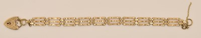 Lot 1520 - A 9ct yellow gold gate link bracelet with...