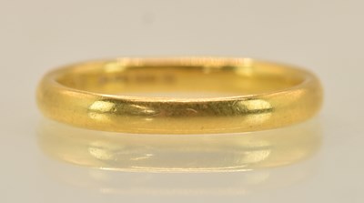 Lot 1343 - A 22ct yellow gold band ring (misshapen),...