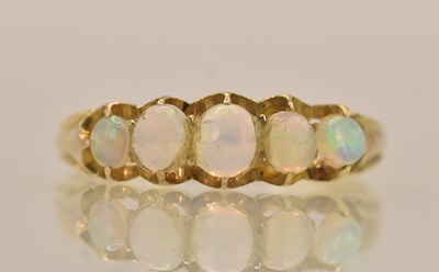 Lot 1374 - A yellow metal opal set five stone ring, size...