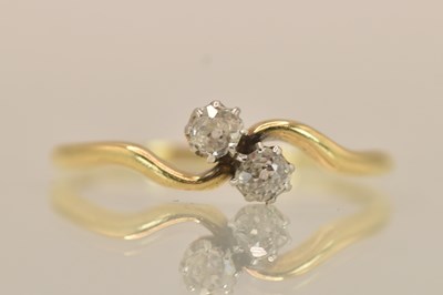 Lot 1375 - A yellow metal diamond set two stone crossover...