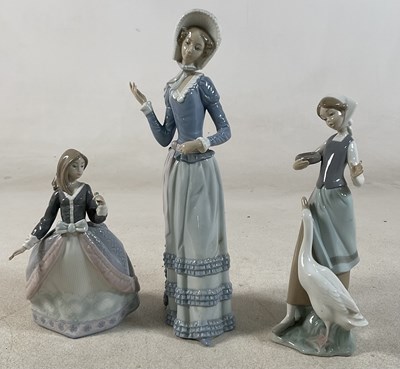 Lot 205 - LLADRO; three figures comprising a young girl...