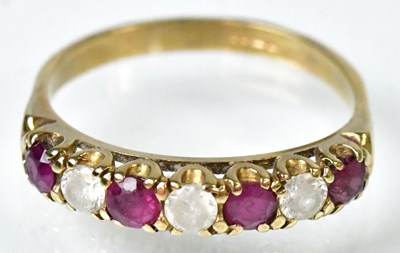 Lot 757 - A 9ct yellow gold half eternity ring set with...