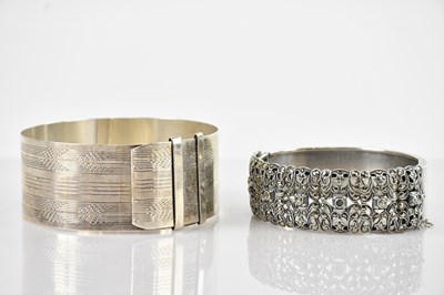 Lot 716 - A sterling silver adjustable bangle, with...