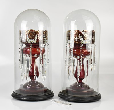 Lot 1587 - A pair of late Victorian cranberry glass table...