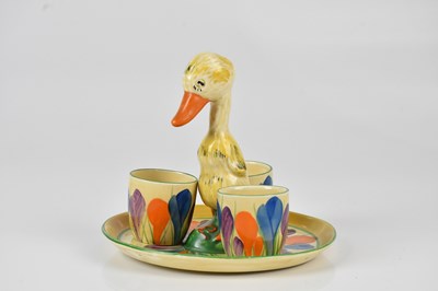 Lot 1557 - CLARICE CLIFF; a four piece egg cup set...