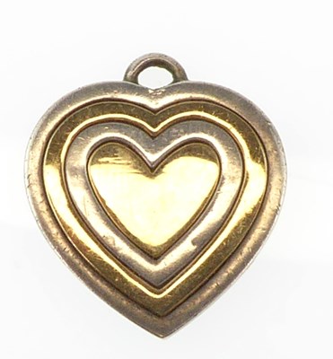 Lot 1032 - GUCCI; a 9ct gold and silver heart-shaped...