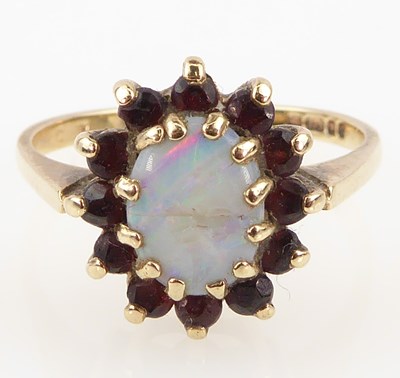 Lot 960 - A 9ct gold opal and garnet dress ring, the...