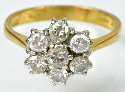 Lot 719 - An 18ct white gold flower ring set with seven...