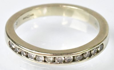 Lot 723 - An 18ct yellow gold diamond half eternity ring,...