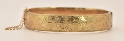 Lot 1517 - A 9ct rose gold hinged bracelet, with half...