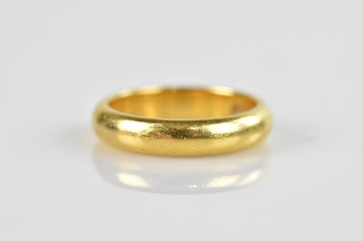 Lot 478 - A 22ct yellow gold wedding band, size O,...