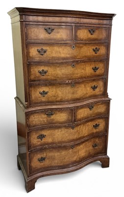 Lot 24 - A reproduction walnut serpentine front chest...