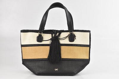 Lot 1435 - ANYA HINDMARCH; a black, tan, and cream straw...