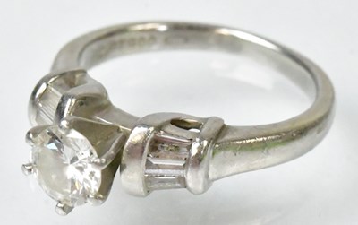 Lot 705 - A platinum ring set with a central diamond,...