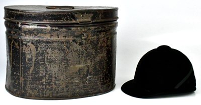 Lot 357 - A Moss Bros. black velvet riding hat with...