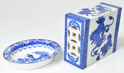 Lot 261 - A Chinese blue and white ceramic opium pillow,...