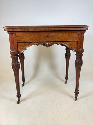 Lot 695 - A walnut card table with leather insert to top...