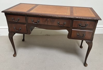Lot 1071 - A reproduction mahogany desk, with five...