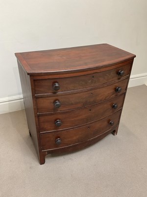 Lot 1107 - A George III mahogany bowfront chest, with...