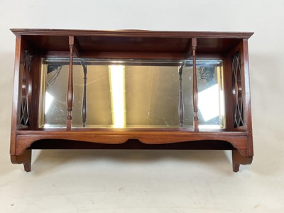 Lot 759 - A mirrored wall shelf