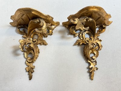 Lot 787 - A pair of ornate gilded wall brackets