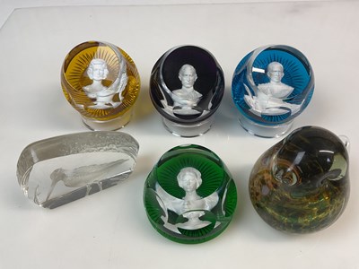 Lot 390 - A group of glass paperweights, comprising four...