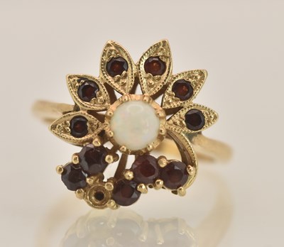 Lot 1378 - A 9ct yellow gold garnet and opal set ring,...