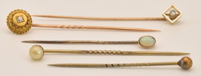 Lot 1304 - Five gold and gold coloured metal tie pins,...