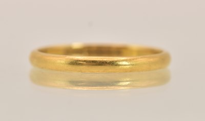 Lot 1363 - A 22ct yellow gold thin band ring, size Q,...