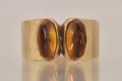 Lot 1355 - A 9ct yellow gold contemporary ring with two...