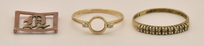 Lot 1417 - A gold ring with open circular centre flanked...