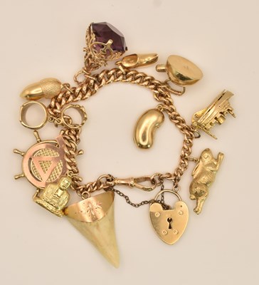 Lot 1512 - A 9ct rose gold charm bracelet with heart...
