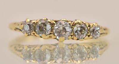 Lot 1265 - An 18ct yellow gold ring set with five...