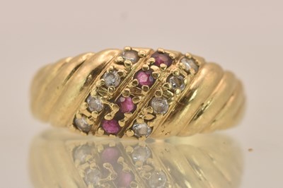 Lot 1400 - A 9ct yellow gold diamond and ruby set ring,...