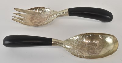 Lot 1268 - A pair of white metal ebony handled salad...
